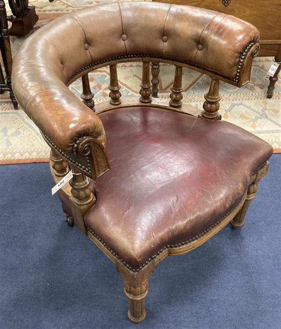 A Victorian walnut tub framed library chair upholstered in faded burgundy leather, width 70cm, depth 62cm, height 74cm